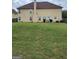 Large backyard with a grassy area and room for outdoor activities at 1158 Folkstone Dr, Mcdonough, GA 30253