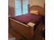 Cozy bedroom featuring a wooden bed frame and burgundy bedding at 1158 Folkstone Dr, Mcdonough, GA 30253