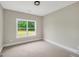 Simple bedroom with carpet and a large window at 585 Highway 155 North N, Mcdonough, GA 30252