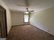 Well-lit bedroom with ceiling fan and carpet flooring at 1381 Durden Rd, Rutledge, GA 30663