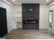 Finished basement with fireplace, built-in shelving, and hardwood floors at 3299 Sims St, Hapeville, GA 30354