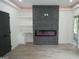 Finished basement with fireplace, built-in shelving, and hardwood floors at 3299 Sims St, Hapeville, GA 30354