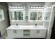 Double vanity bathroom with modern fixtures and LED lighting at 3299 Sims St, Hapeville, GA 30354