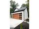 Detached garage with modern wood and glass garage door at 3299 Sims St, Hapeville, GA 30354