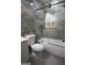 Bathroom with toilet, bathtub, and sliding glass door at 3299 Sims St, Hapeville, GA 30354