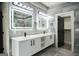 Modern bathroom with double vanity, large mirrors, and walk-in shower at 3299 Sims St, Hapeville, GA 30354