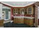 Wet bar with wooden cabinetry, wine rack, and glass doors at 115 Eagles Club Dr, Stockbridge, GA 30281