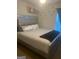 Bedroom with gray upholstered bed at 2237 Wind Rose Ct, Lithonia, GA 30058