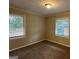 Spacious bedroom with neutral walls, carpet flooring, and two windows at 2241 Sharon Way, Decatur, GA 30032