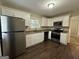 Modern kitchen with white cabinets, granite countertops, and stainless steel appliances at 2241 Sharon Way, Decatur, GA 30032
