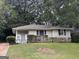 Brick ranch house with a well-maintained lawn and mature trees at 2241 Sharon Way, Decatur, GA 30032