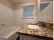 Clean bathroom with granite vanity and a bathtub at 2241 Sharon Way, Decatur, GA 30032