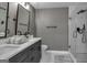 Modern bathroom with gray double vanity, quartz countertop and a glass shower at 2029 Detroit Nw Ave, Atlanta, GA 30314