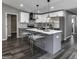 Modern kitchen with gray island, white cabinets, and stainless steel appliances at 2029 Detroit Nw Ave, Atlanta, GA 30314