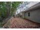 Side yard with mature trees and wooden fence at 120 Cannon Dr, Fayetteville, GA 30214