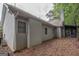 Rear view of house showcasing stucco siding and screened porch at 120 Cannon Dr, Fayetteville, GA 30214