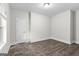 Simple bedroom with gray vinyl flooring and white door at 26 Pool Woods Dr, Grantville, GA 30220