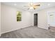 Bright bedroom with neutral carpeting, ceiling fan, and walk-in closet at 1754 Tiger Flowers Nw Dr, Atlanta, GA 30314