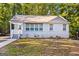 Charming renovated ranch home with a white brick exterior, front porch, and landscaped yard at 1754 Tiger Flowers Nw Dr, Atlanta, GA 30314