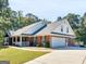 Two story home with attached garage and landscaping at 1036 Locust Rd, Locust Grove, GA 30248