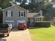 Gray house with two-car garage and landscaped yard at 110 Gwenellen Dr, Locust Grove, GA 30248