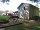Gray house with deck, fire pit, and fenced yard at 110 Gwenellen Dr, Locust Grove, GA 30248