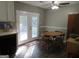 Dining area with table and chairs, and access to deck at 110 Gwenellen Dr, Locust Grove, GA 30248