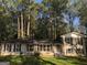 Ranch-style home with a large yard and mature trees at 4330 Cedar Valley Ln, Conley, GA 30288