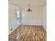Bright dining room with hardwood floors and modern light fixture at 4330 Cedar Valley Ln, Conley, GA 30288