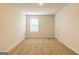 Well-lit bedroom with carpet and window at 309 Brooks Dr # 74, Fairburn, GA 30213