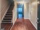 Inviting entryway with dark wood stairs and laminate flooring at 675 Georgetown Ct, Jonesboro, GA 30236