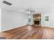 Living room with stone fireplace, hardwood floors and neutral wall colors at 9091 Raven Dr, Jonesboro, GA 30238