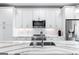 Modern kitchen with white cabinets, quartz countertops, and stainless steel appliances at 395 Pratt Se Dr # 802, Atlanta, GA 30315