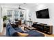 Living room features a sectional sofa, dining table, and large TV at 395 Pratt Se Dr # 802, Atlanta, GA 30315