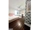 Large bedroom with dark hardwood floors and built-in shelving at 45 Carroll Ln, Temple, GA 30179