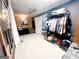 Bedroom with dark walls, wood-paneled accent wall, and clothing rack at 45 Carroll Ln, Temple, GA 30179