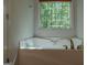 Bathroom with jetted bathtub and a window at 5447 Centry Dr, Villa Rica, GA 30180