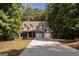 Two-story house with a brick facade and a two-car garage, nestled in a wooded area at 5447 Centry Dr, Villa Rica, GA 30180