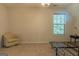 Bright bedroom with carpeted floor, a chair, and a window with blinds at 5447 Centry Dr, Villa Rica, GA 30180