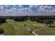 Aerial view of a golf course community with lush green fairways and mature trees at 5447 Centry Dr, Villa Rica, GA 30180