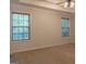 Spacious bedroom with neutral walls, carpeting, and two large windows at 5447 Centry Dr, Villa Rica, GA 30180