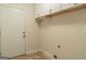 Bright laundry room with white cabinets, tile floor, and exterior access at 5447 Centry Dr, Villa Rica, GA 30180