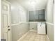 Bright laundry room with washer, dryer, cabinets, and tiled floor at 1196 Burbank Trl, Morrow, GA 30260