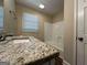 Clean bathroom with granite countertop and a bathtub at 3869 Rosedale Ln, Douglasville, GA 30135