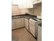 Galley-style kitchen with white cabinets and dark countertops at 5914 Sutcliff Sq, Lithonia, GA 30058