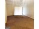Bright living room with carpeted floors and sliding glass doors at 5914 Sutcliff Sq, Lithonia, GA 30058