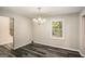 Bright dining room with wood-look floors and chandelier at 23 Club Dr, Locust Grove, GA 30248