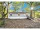 Gray house exterior with a ramp, surrounded by trees at 23 Club Dr, Locust Grove, GA 30248