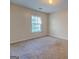 Well-lit bedroom with carpet and window at 2219 Sw Palomino Ln, Conyers, GA 30012