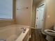 Main bathroom with garden tub and separate shower at 9585 Lakeview Cir, Union City, GA 30291